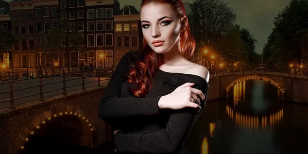 Amsterdam Escort posing in an elegant black evening dress