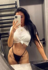 Attractive brunette escort taking a mirror selfie in Havana Hotel bathroom, Amsterdam