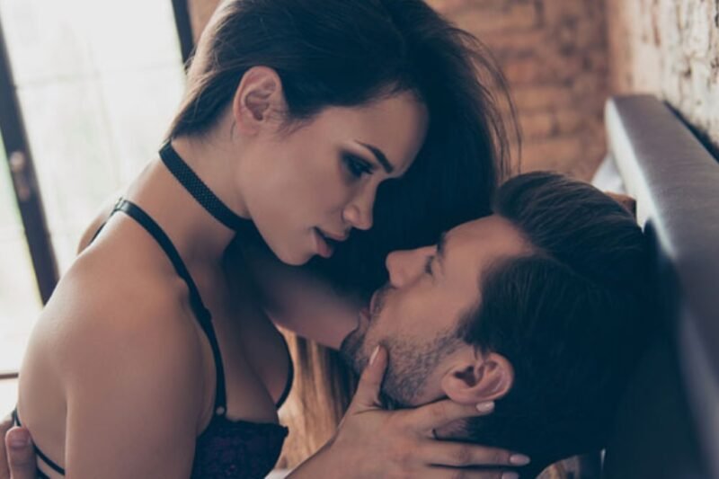 Elegant escort woman whispering in man's ear during intimate session in Amsterdam